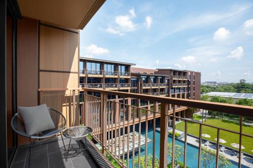 a balcony with a view of a building at Courtyard by Marriott Bangkok Suvarnabhumi Airport in Lat Krabang