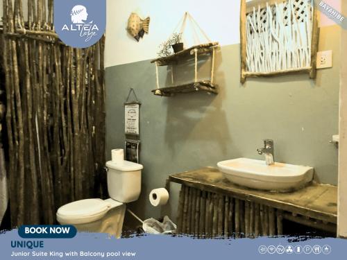 a bathroom with a toilet and a sink at Bayahibe Lodge in Bayahibe