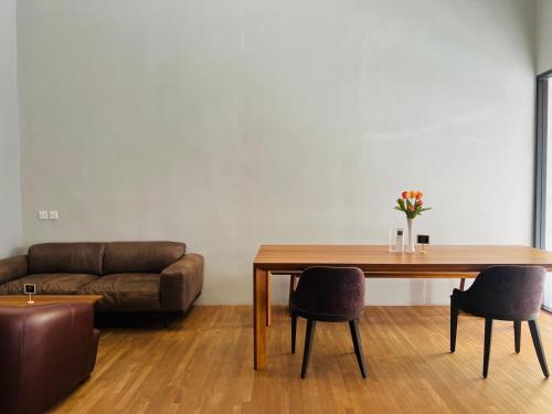 a living room with a table and a couch at Woodstory Boutique Hotel in Bangkok