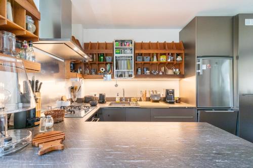 a kitchen with a stainless steel refrigerator and a counter at Vue plongeante sur l'eau in Saint-Jean-de-Luz
