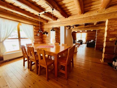 a dining room with a wooden table and chairs at Fifth Element Retreat in Borzont