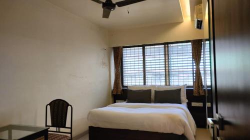 a bedroom with a large bed and a window at Hotel Sai Nidhi Executive-MindSpace Airoli Navi Mumbai in Navi Mumbai