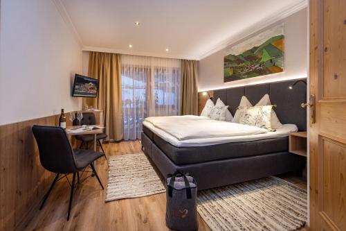 Pokój hotelowy z łóżkiem i biurkiem w obiekcie Boutique Hotel Martha w mieście Zell am See