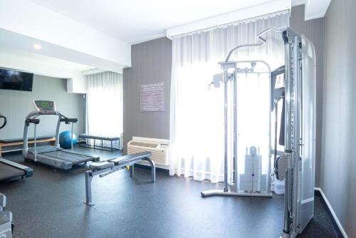 a gym with two tread machines and a window at Sandman Hotel Calgary Airport in Calgary