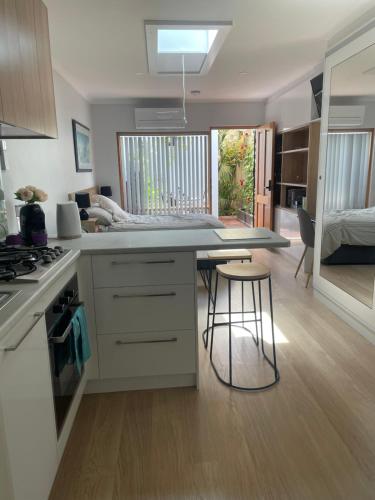 a kitchen with a kitchen island with a counter top at oasis by the beach in Glenelg