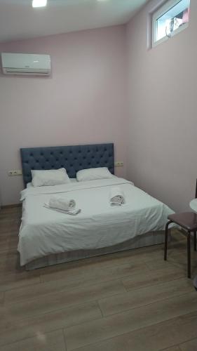 a bedroom with a large bed with white sheets at Family Hotel Avlabar in Tbilisi City