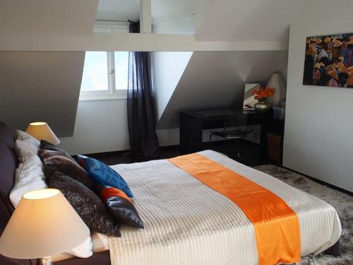 a bedroom with a bed with pillows and a window at Beautiful French mountain home in Marignier