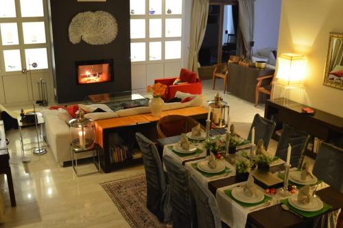 a living room with a table and a couch at Beautiful French mountain home in Marignier