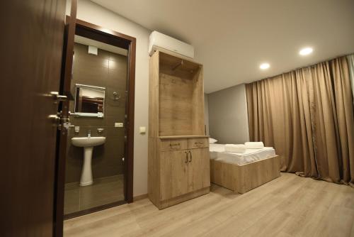 a bathroom with a toilet and a sink and a shower at Family Hotel Avlabar in Tbilisi City