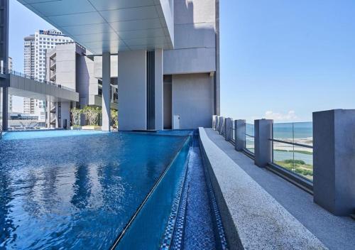a swimming pool on the side of a building at Imperio Residence Melaka by Jeffery Lam Home Management in Melaka