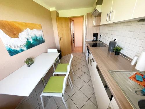 a kitchen with a counter and some chairs in it at Apartment in Geseke in Geseke