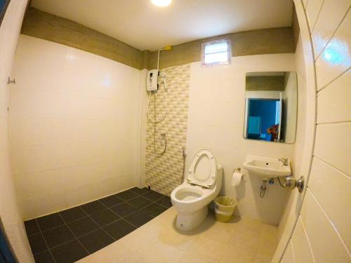 a bathroom with a toilet and a sink at Downtown Kohlarn Resort in Ko Larn