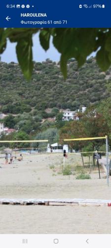 a view of a soccer field with a volley ball at Maria Apartments in Néa Karváli