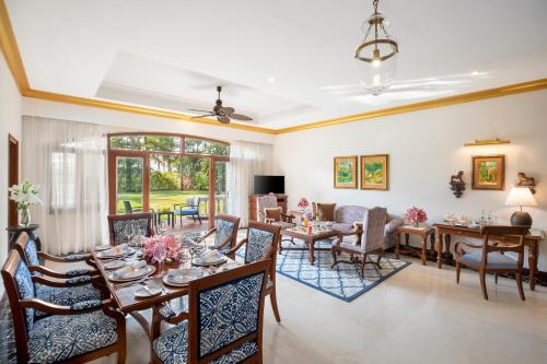 a living room with a table and chairs at Taj Exotica Resort & Spa, Goa in Benaulim
