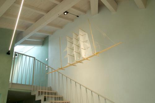 a white boat hanging on the wall of a building at PALAZZO CIOPETA - Italian Excellence in Verona