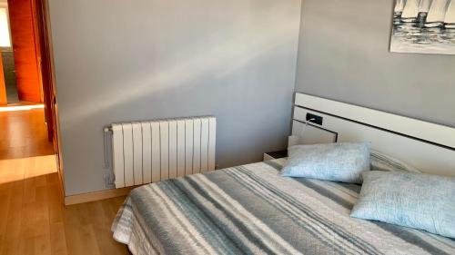 a small bedroom with a bed and a radiator at Apartamento Ginette SunBeach in Salou