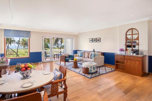 a living room with a table and a couch at Taj Exotica Resort & Spa, Goa in Benaulim