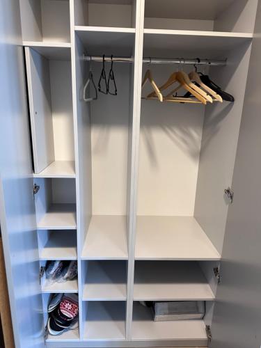 a walk in closet with white cabinets at Apartmán Ferula in Stará Lesná