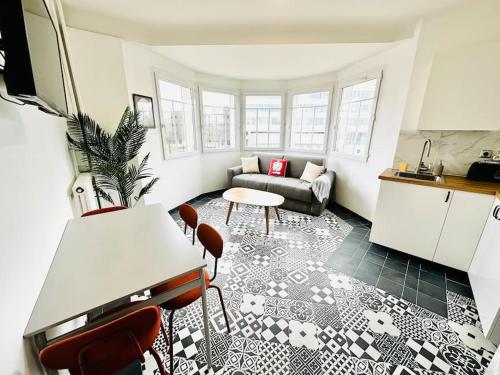 a living room with a couch and a table at Le Gentil Rooftop in Gentilly