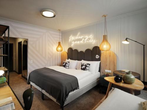a bedroom with a bed and a sign that reads happy birthday at PLACES Obertauern by Valamar in Obertauern