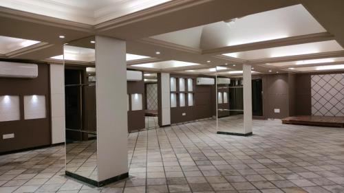 a large room with columns and a ceiling at Hotel Sai Nidhi Executive-MindSpace Airoli Navi Mumbai in Navi Mumbai