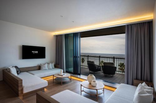 a living room with a view of the ocean at seven x seven Itoshima in Itoshima