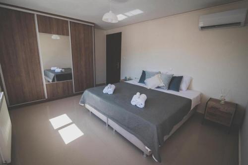 1 dormitorio con 1 cama con toallas en Mardel_seaside_selinia, en Salamina
