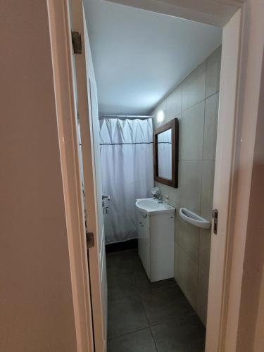 a small bathroom with a sink and a toilet at El montañes in San Carlos de Bariloche
