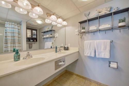 a bathroom with a sink and a large mirror at 2501 S Ocean Blvd, 1031 - Ocean View Sleeps 8 in Myrtle Beach