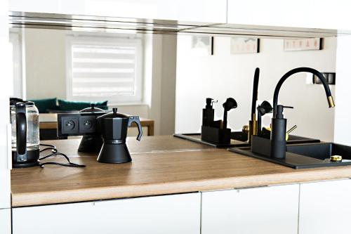 a kitchen counter with several appliances on it at Apartamenty Parkowa 9 in Lesko
