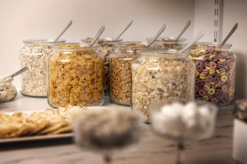 a group of jars filled with different types of nuts at Hotell Skövde in Skövde