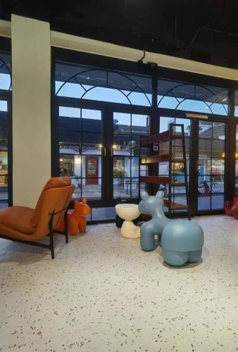 a room with chairs and furniture in a building at 不负韶华青年旅馆 Youth Hostel in Suzhou