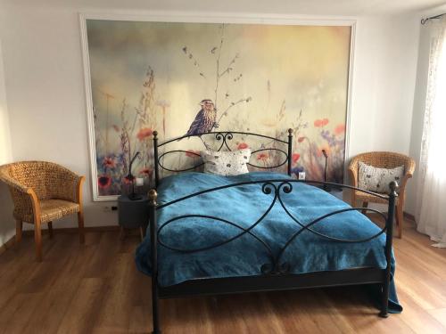 a bedroom with a bed with a painting on the wall at Ferienwohnung "Frieda" 