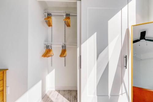 a hallway with white walls and orange curtains at Downtown 2br w lounge deck wd pool ATX-231 in Austin