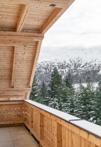 a balcony with a view of snow covered mountains at Bergchalet "Haus Sonja" in Katschberghöhe