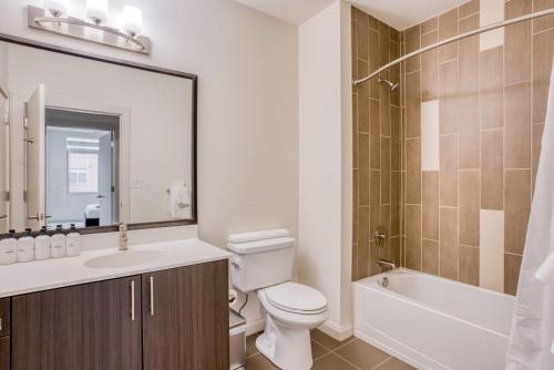 a bathroom with a toilet and a sink and a shower at Waltham 2br w gym wd near restaurants BOS-970 in Waltham
