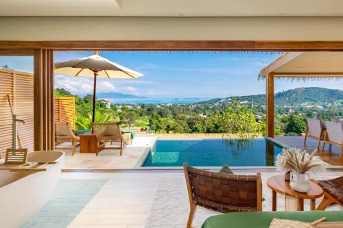 a house with a pool and a patio with a view at Wild Cottages Elephant Sanctuary Resort in Amphoe Koh Samui