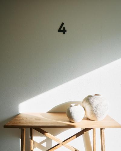 two vases sitting on top of a wooden table at seven x seven Itoshima in Itoshima