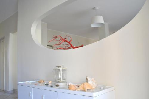 a white room with a mirror and stuffed animals on a cabinet at Hotel Sette Note in Silvi Marina