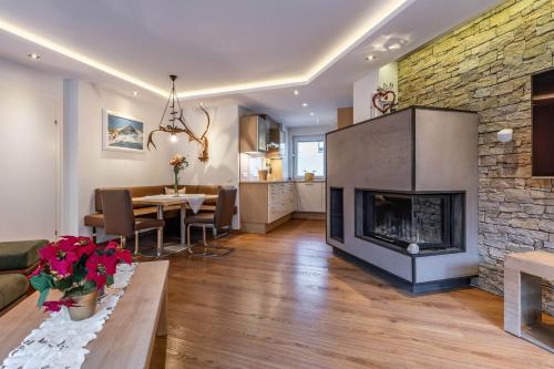 a living room with a fireplace and a dining room at Appartement Perauer in Mayrhofen