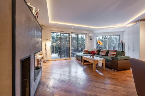 a living room with a couch and a fireplace at Chalet Perauer in Mayrhofen