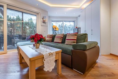 a living room with a couch and a table at Chalet Perauer in Mayrhofen