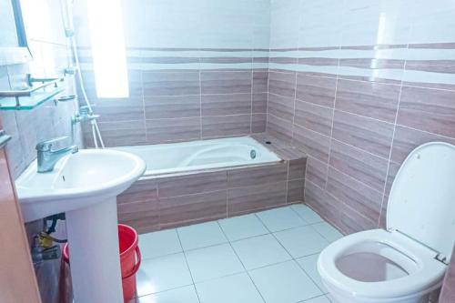 ein Badezimmer mit einer Badewanne, einem WC und einem Waschbecken in der Unterkunft Atlantic Resort in Jaliapāra