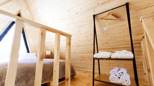 a bedroom in a log cabin with a bed and towels at Kamara in Sioni