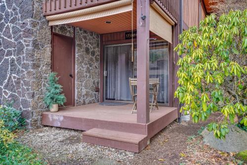 a porch of a house with a table and a chair at Cozy Nest Condo in Welches in Mount Hood Village