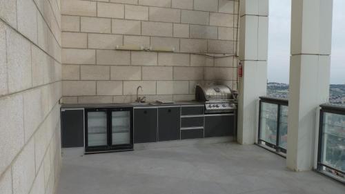 a kitchen with a sink and a stove in a building at JTower Royal Suites - The Penthouse - Alefimmoed in Jerusalem