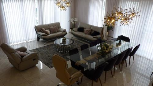 a living room with a glass table and a couch at JTower Royal Suites - The Penthouse - Alefimmoed in Jerusalem
