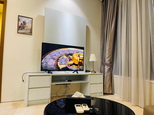 a living room with a television on a table at Vortex suites klcc by Yashrib in Kuala Lumpur