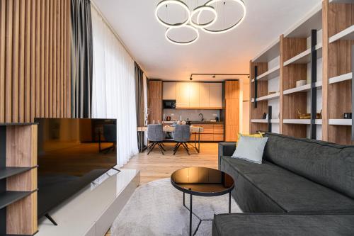 a living room with a couch and a table at KOA - Fidelio Apartments in Braşov