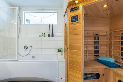 a bathroom with a shower and a bath tub at Ferienwohnung Hafenblick in Olpenitz